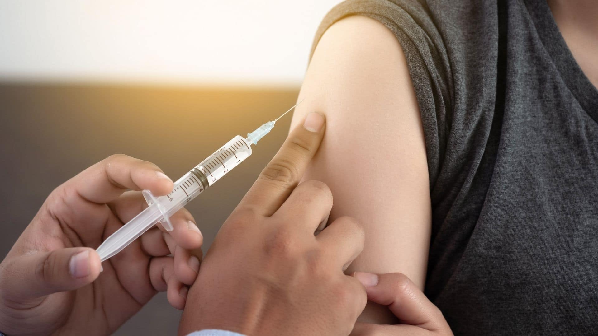 vaccination needle going into arm